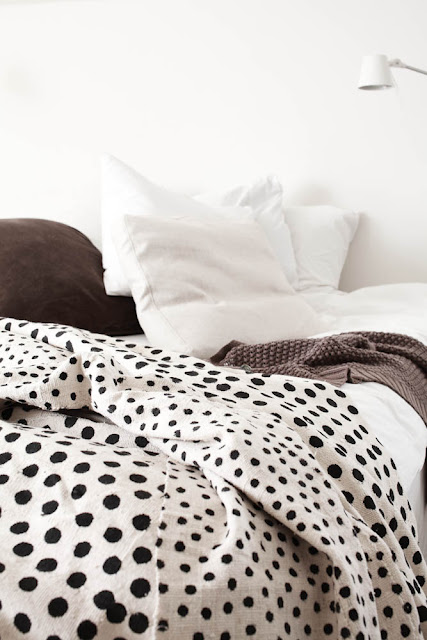 alternative photo of white bedroom with ikata polka dot duvet cover with brown pillow and sweater