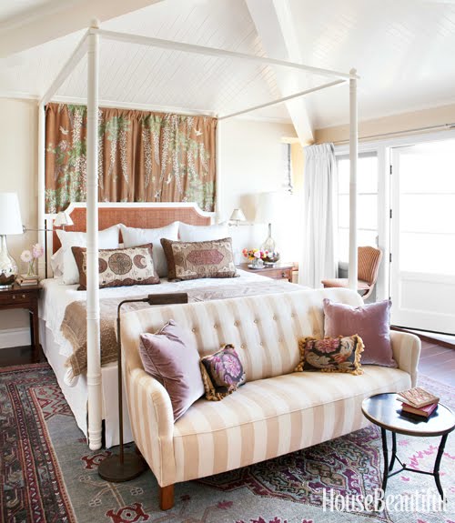 bedroom with canopy bed, a striped sofa and gorgeous accent pillows by Peter Dunham