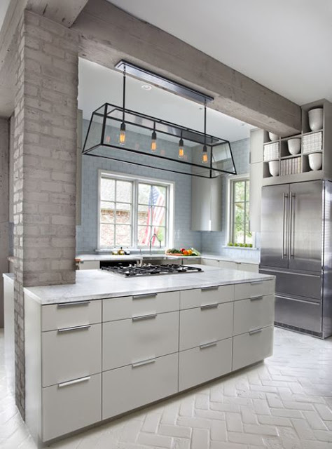 kitchen with painted gray columns with white cabinets and silver french door fridge