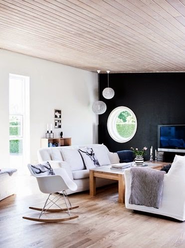 Living room with black accent walls and white sofas