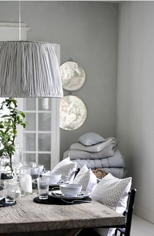 Grey dining room in a Danish home pendant light decorative pillows