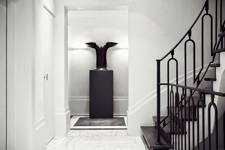 White foyer with black staircase