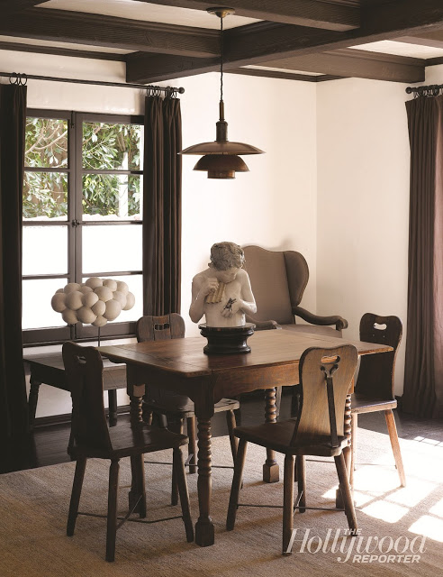 breakfast nook with pendant light, white walls, large windows and floor length brown curtains