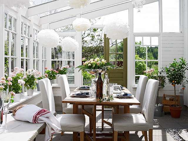 Atrium dining room glass ceiling and windows cottage white reclaimed wood table