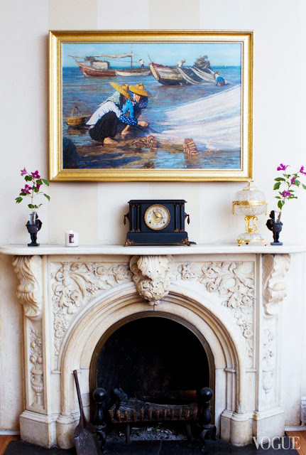 Traditional fireplace mantel with striped walls, a traditional oil painting and antique clock