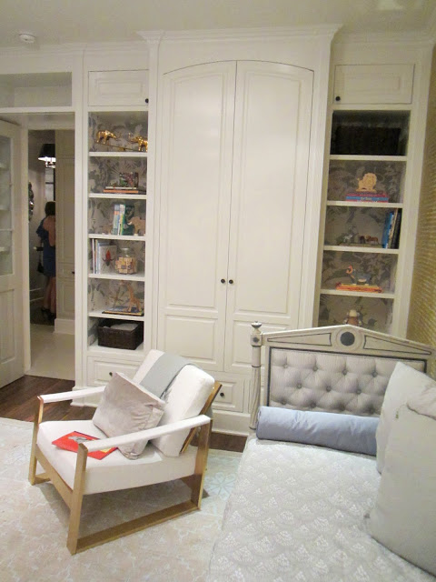 Built in bookshelves and cabinets in the baby room in the Windsor house, the bookshelves are lined with Schumacher's "Jungle Play" wall covering 
