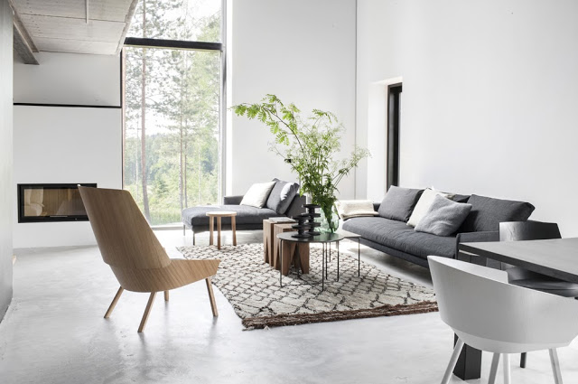 Modern neutral living room grey sofa wood chair white walls large window