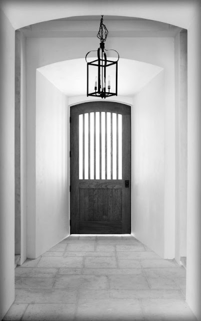 black front door white walls foyer entryway entry iron lantern