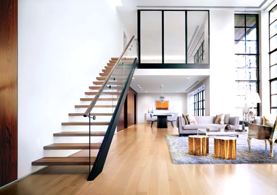Modern New York City Apartment glass staircase railing light wood floor shag rug tree stump side table