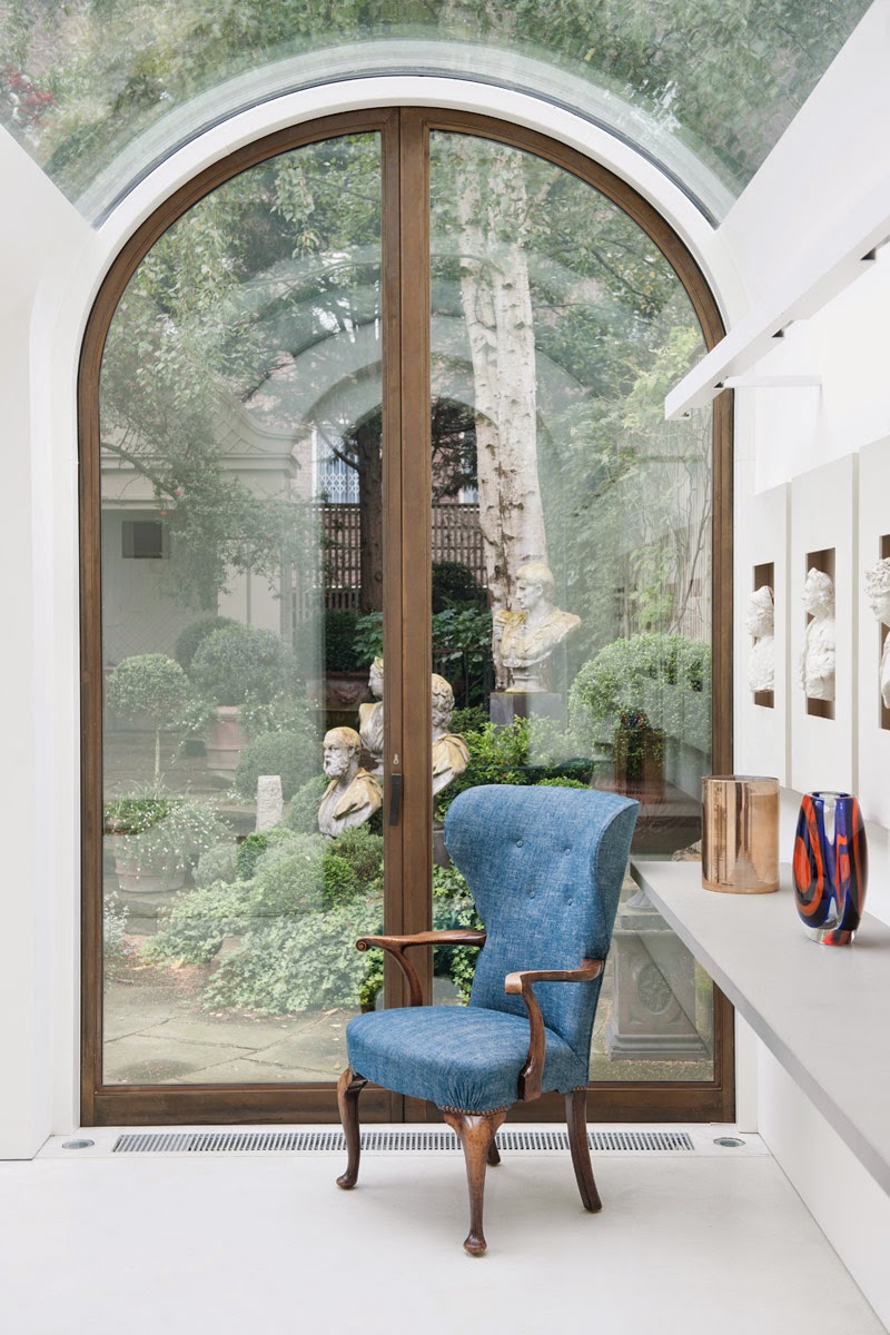 Arched glass door in a mews townhouse by Andy Martin Architects