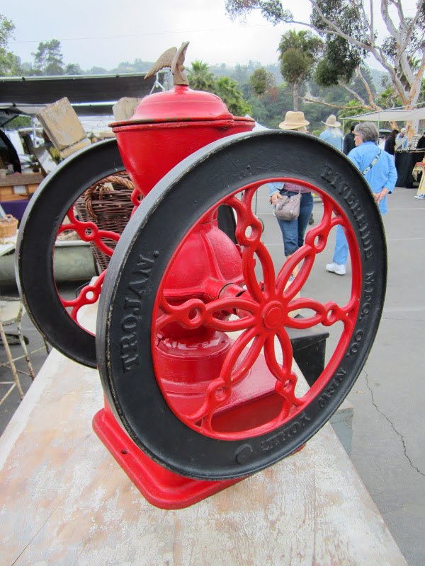 A bright red antique coffee grinder