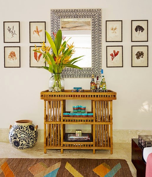 Bamboo side table and graphic mirror in a home by Juan Montoya