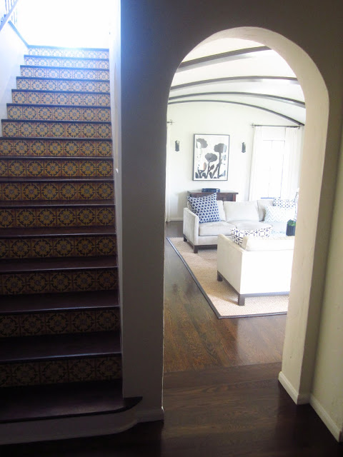 foyer with staircase with Spanish tiles and view into living room