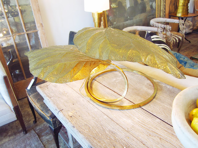 vintage brass table lamp in the form of large leaves on a wood table