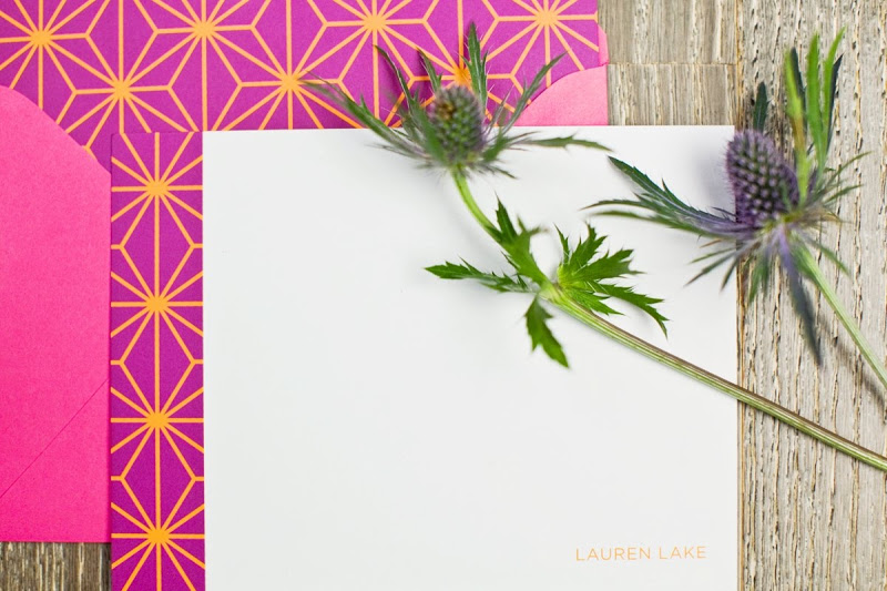 Magenta card with gold graphic line design on it, a hot pink envelope and a thistle