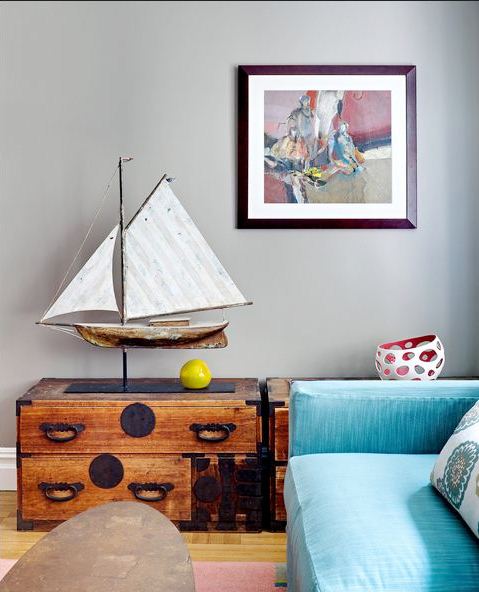 den with blue blue, reclaimed wood trunk as side table with a sail boat weather vane