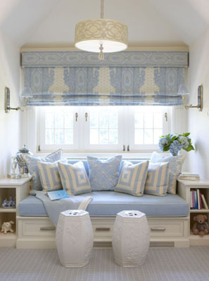 Blue and white built in window seat with blue and white roman curtains, Chinese garden jars as footstools and white book case