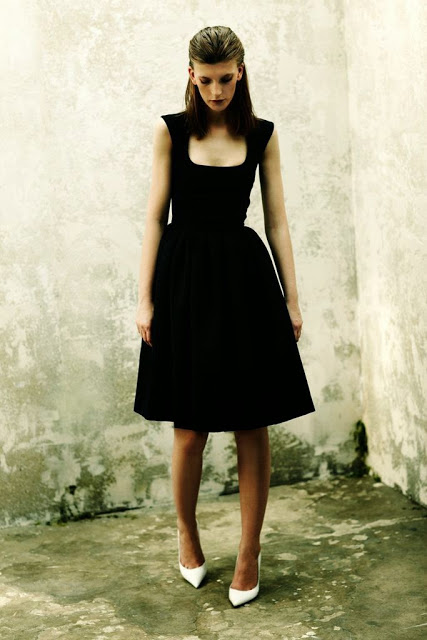 Model wearing black dress and white shoes