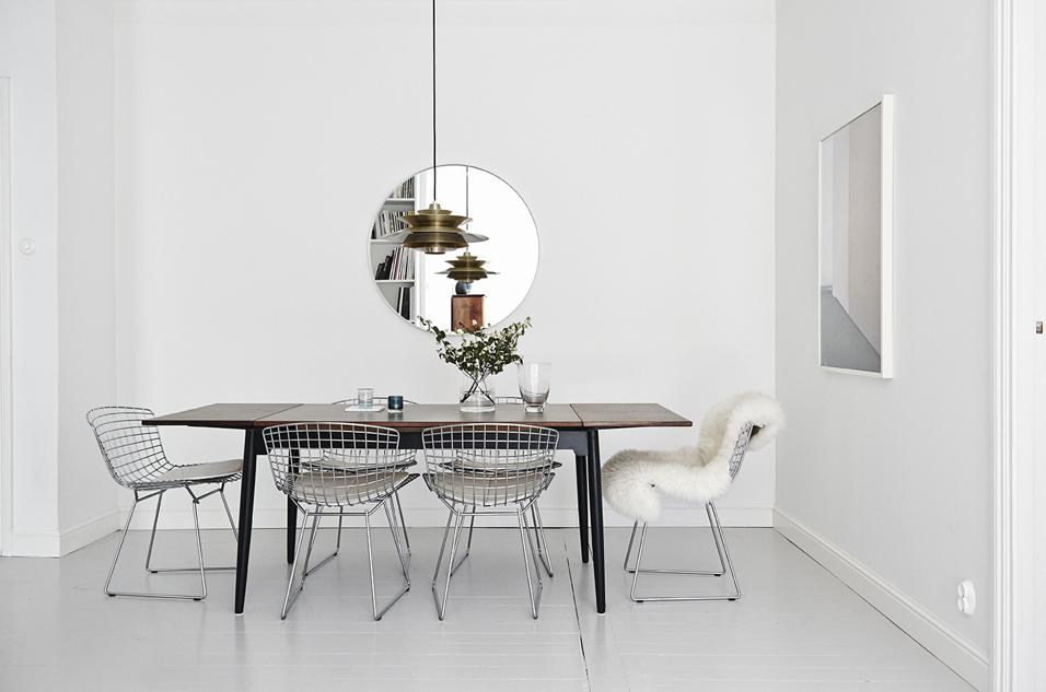 Modern black and white dining room with wire chairs
