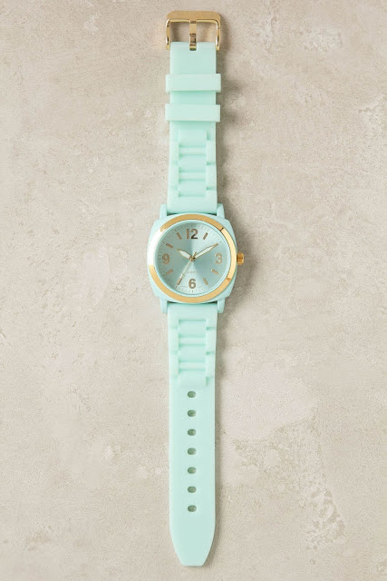 mint green watch with gold accents on the face