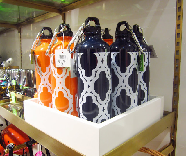 orange and navy metal water bottles in a square white box