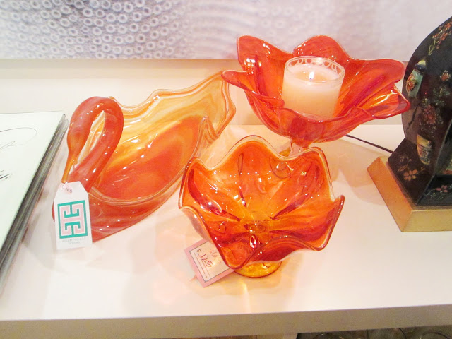 Three vintage orange glass dishes: two flowers and one swan