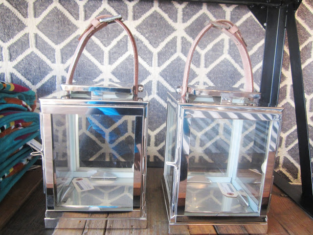 polished metal lanterns with a leather strap