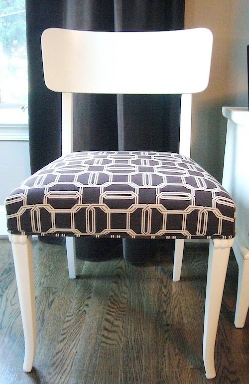 Dining room chair painted bright white and upholstered with Kelly Wearstler's brown Emerald Cut fabric on the seat