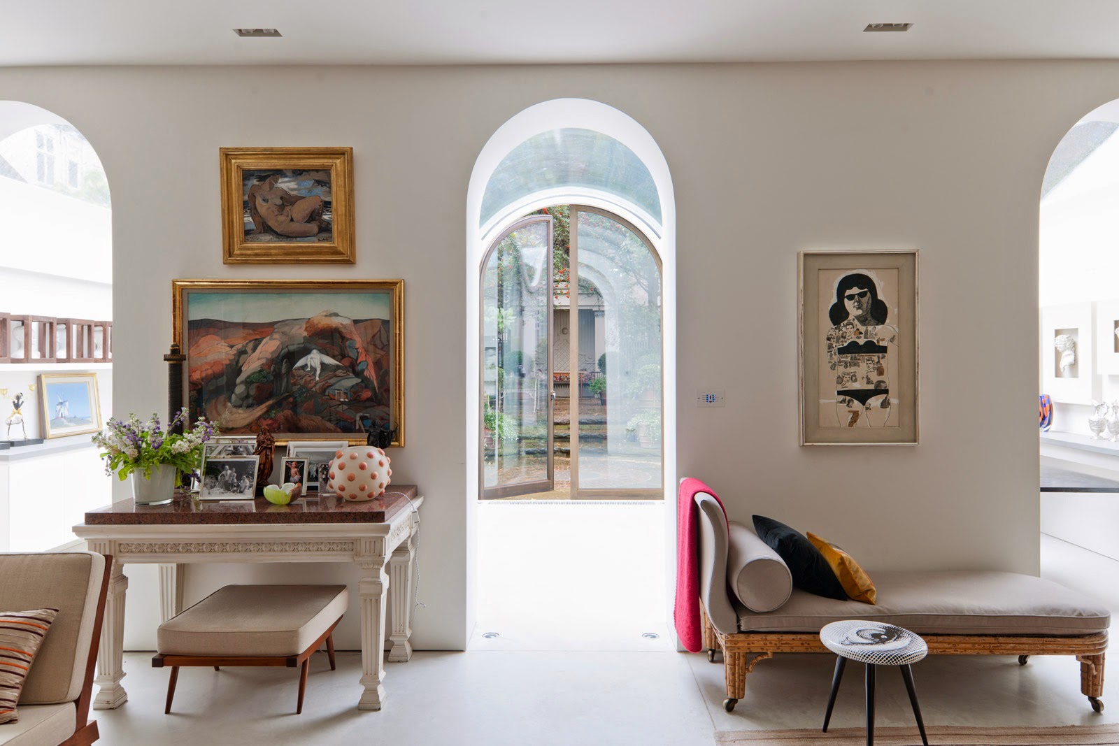 Living room with arched entryway in a mews townhouse by Andy Martin Architects