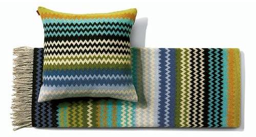 Matching throw and cushion with the classic Missoni zig zag multicolored stripe pattern in cream, green, navy and turquoise