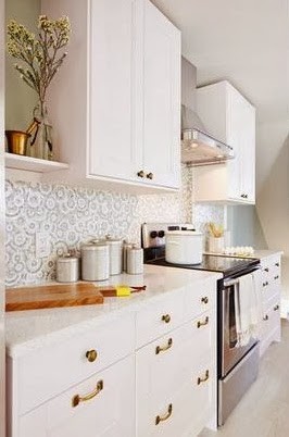 White kitchen after makeover with white counters and brass accents