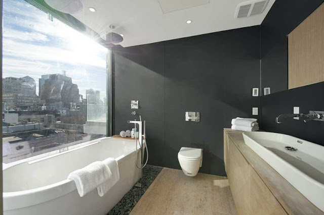master bathroom with stand alone tub, custom vanity and black walls with an amazing view of the city