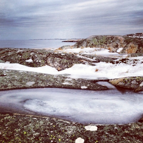 Tidal pool frozen solid off the coast of Sweden in winter