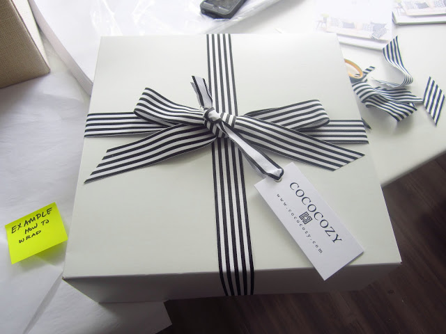 COCOCOZY gift box with black and white stripped ribbon on a white table at COCOCOZY HQ