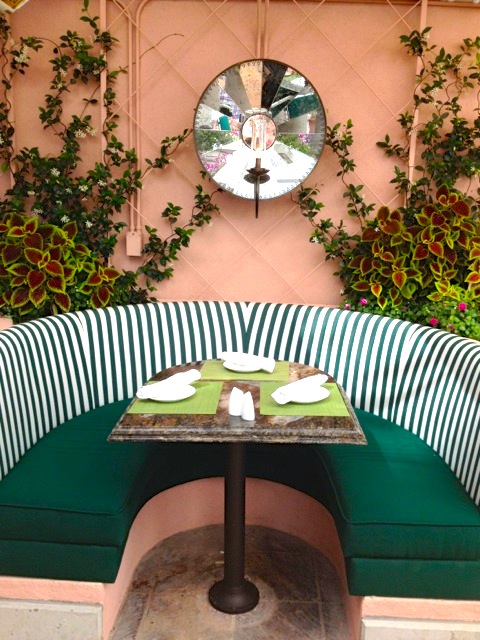 Outdoor green and white striped booth poolside restaurant 