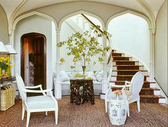 foyer moroccan arches nailhead trim walls sisal carpet louis chair garden stool tree