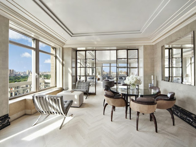 Informal dining room in a NYC penthouse with a view of central park, Barcelona chairs and modern furniture