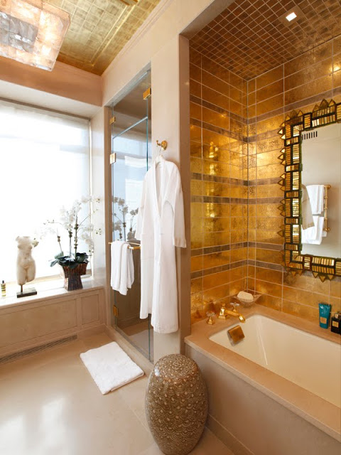 Bathroom with gold tiles and a step in tub