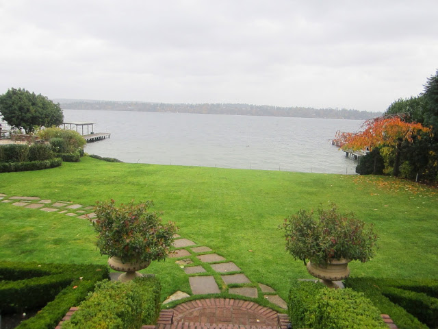 Lake Washington estate with a lake view, grassy yard and a stone path on a cloudy day