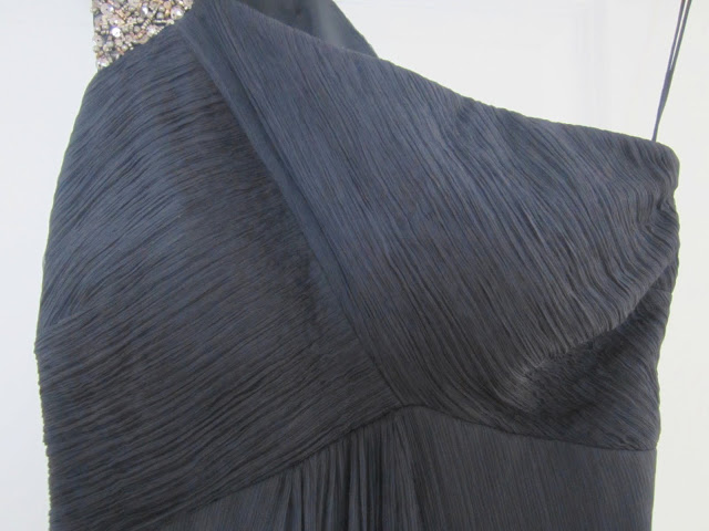 Close up of the bust on the navy silk beaded one shoulder Carlos Miele gown