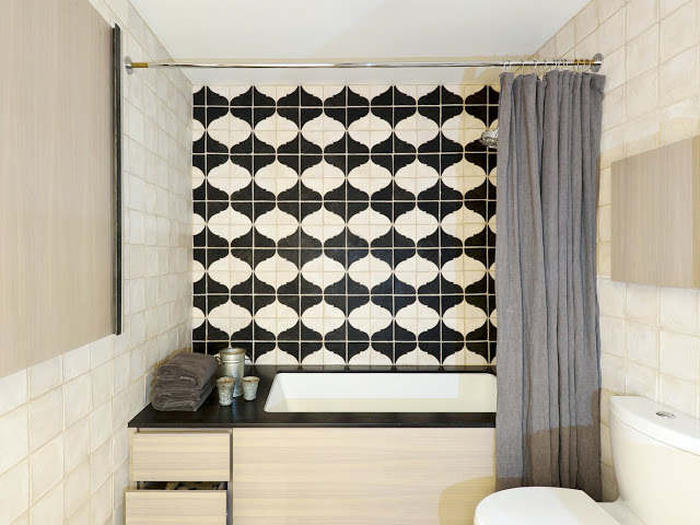 black and white Moroccan tiles in a bathroom with a platform tub by Workstead