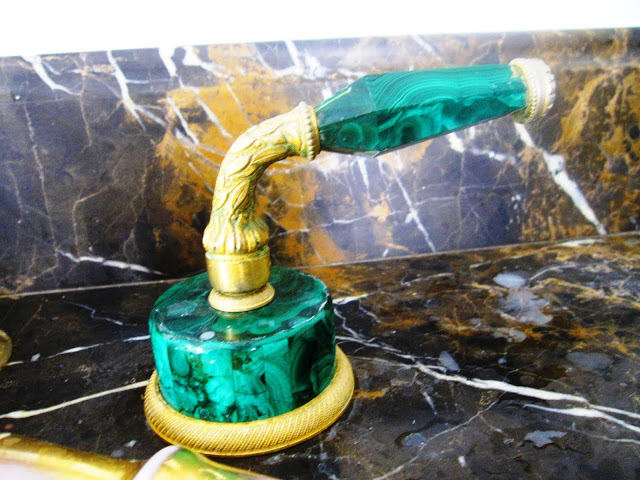 Gold and malachite faucet handle in the master bathroom