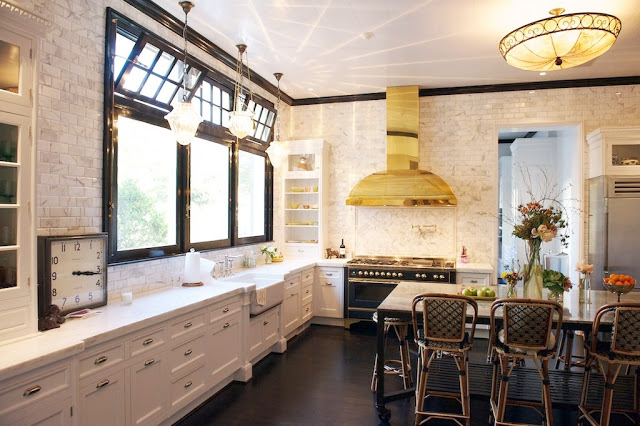 Kitchen with marble subway walls, white cabinets, dark wood floors, black trimmed windows, vintage light fixture over the island and Drucker's French Bistro barstools
