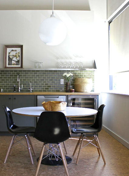 Breakfast Nook with round table and black Eames chairs in a home designed by Krista Schrock and David John Dick