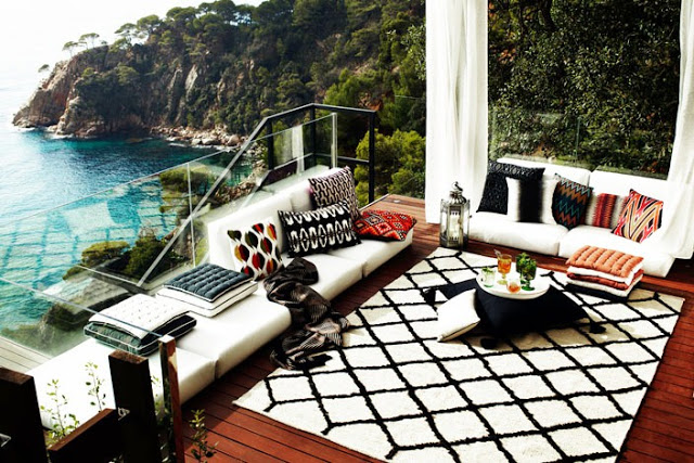 deck patio cliff cliffside ocean sea view outdoor living room moroccan rug built in furniture