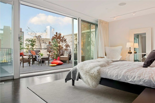 Bedroom in a Soho Condo in New York City that overlooks a balcony