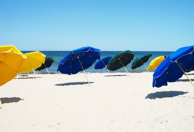 Blue, yellow and green umbrellas on a beach in Nantucket 