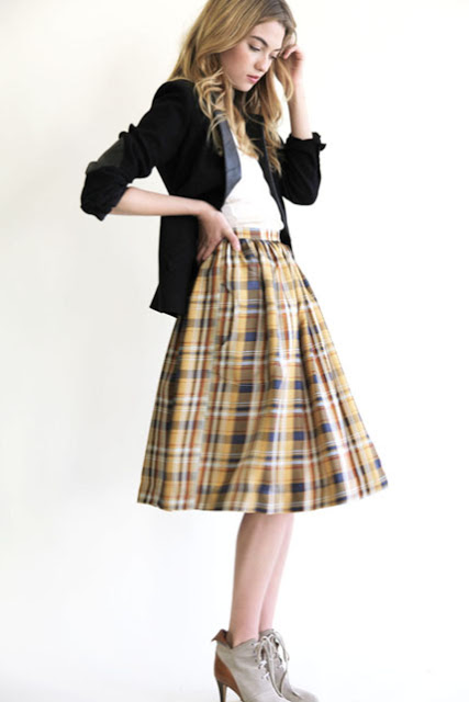model wears Heidi Merrick's yellow plaid Henry Skirt with a white t-shirt, a black blazer and ankle boots