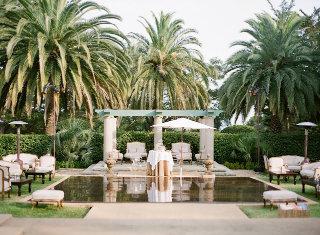 lounge area at a Montecito spring wedding reception with upholstered Louis armchairs and setteesdesigned by Yifat Oren