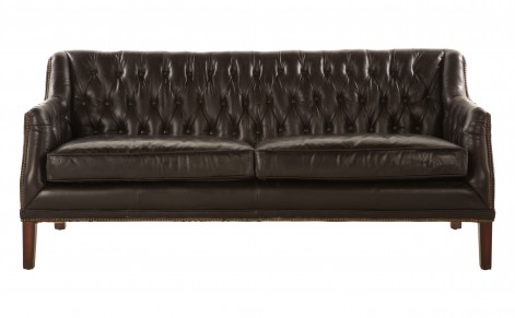 Upholstered vintage black leather sofa with brass nail heads and a tufted back